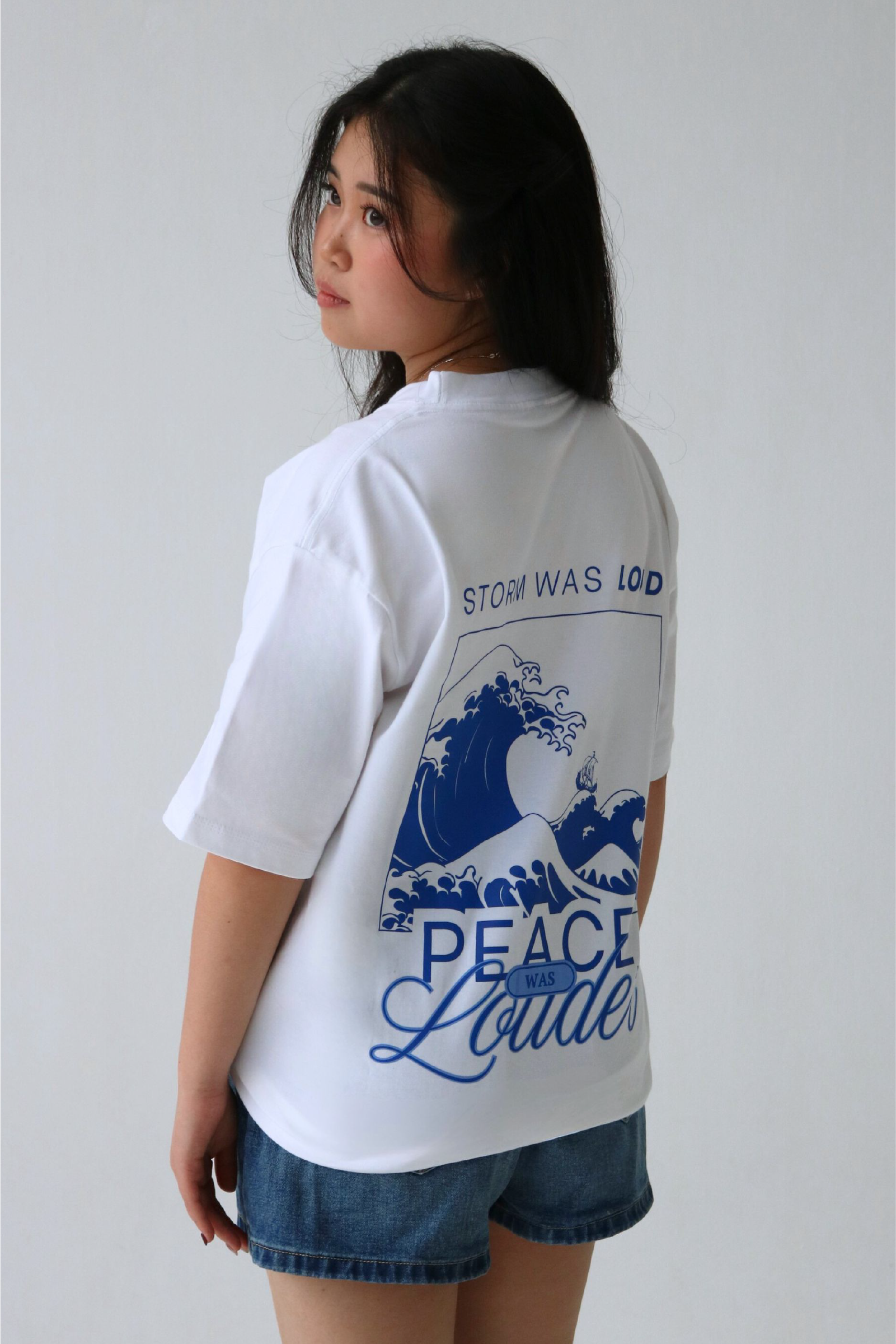 Oversized graphic white T-shirt back design - "Storm was loud, peace was louder"